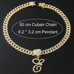 Detail of 50cm gold Cuban link chain with large iced out heart and letter C pendant