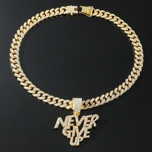 Close-up of golden Cuban chain with iced out NEVER GIVE UP letter pendant