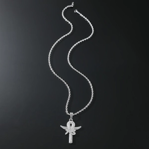 Detailed macro view of silver Ankh cross pendant with sparkling wings and rope chain