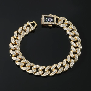 Golden 13mm iced out Cuban link bracelet with dollar sign clasp on black mirror background