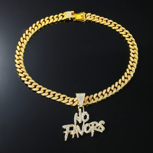 Close-up of golden Cuban link necklace with iced-out NO FAVORS letter pendant and diamonds