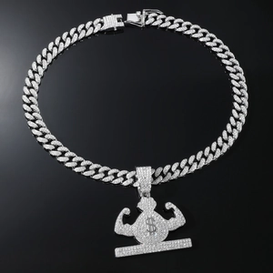 Macro shot of iced-out Cuban chain and muscle money bag pendant with silver rhinestones