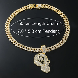 Macro shot of hip hop emoji pendant with full rhinestones and 50cm golden Cuban chain