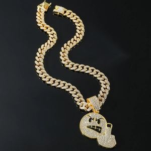 Gold iced out hip hop necklace featuring an emoji pendant with a gun and Cuban chain
