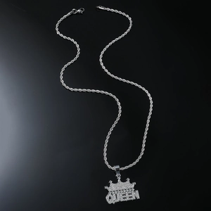 Macro shot of silver hip-hop QUEEN pendant with crown and iced-out zircon stones