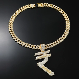 Close-up of golden iced-out Indian Rupee symbol pendant on sparkling Cuban link chain
