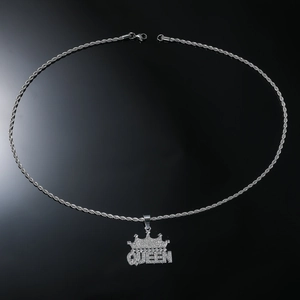 Close-up of silver-tone QUEEN crown pendant with sparkling crystals and a thick rope chain