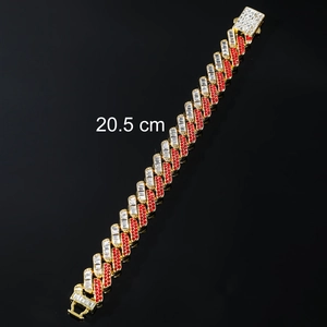 Macro shot of 20.5 cm 15mm gold Cuban link bracelet with red and white pavé cubic zirconia