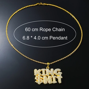 Macro detail of iced-out KING SHIT hip hop pendant with 60cm gold rope chain