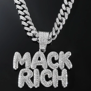 Macro shot of silver Cuban chain with MACK RICH iced out diamond letter pendant