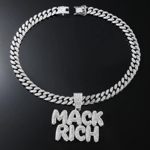 Macro view of iced out MACK RICH letter pendant on a silver Cuban link chain