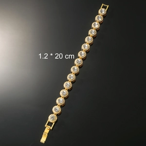 Detail shot of golden tennis bracelet with round crystals measuring 1.2 x 20 cm