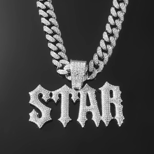 Close-up of oversized iced-out STAR pendant with silver Cuban link chain for men