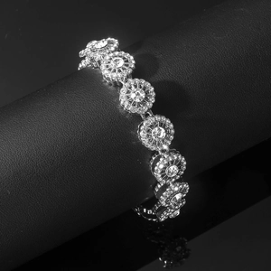 Detailed close-up of sparkling flower chain links with silver rhinelstones on black leather