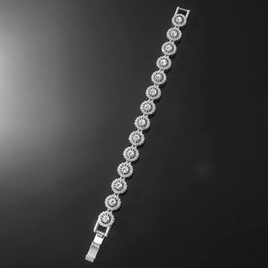 Macro detail of silver hip hop bracelet with sparkling white zircon pave floral links