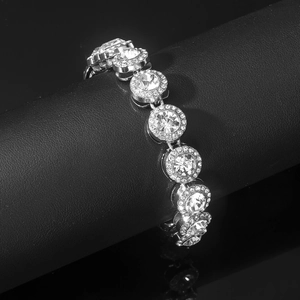 Macro detail of silver Cuban link bracelet with sparkling round zircon gemstone clusters