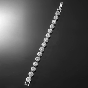 Close-up of silver Cuban chain bracelet with round diamond-set links on black background