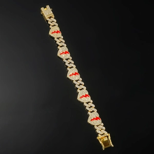 Detailed view of hip hop gold Cuban link bracelet with iced out red lightning hearts