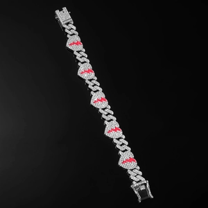 Close-up of iced out Cuban link bracelet with red lightning heart design and stones