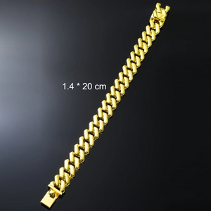 Detailed view of golden Cuban link chain bracelet with polished finish and secure clasp
