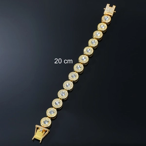 Macro view of 20cm gold plated iced out hip hop bracelet with sparkling round crystals
