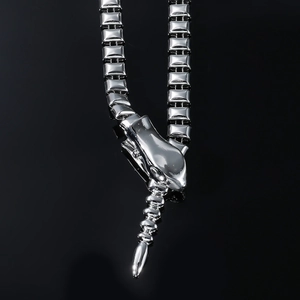 Polished silver snake-shaped necklace with geometric links shown in a mirror reflection