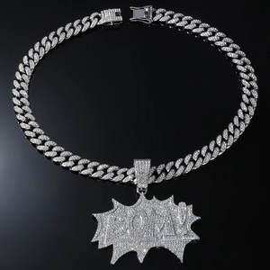 Macro shot of silver hip hop necklace with icy BOOM pendant and thick cuban chain links