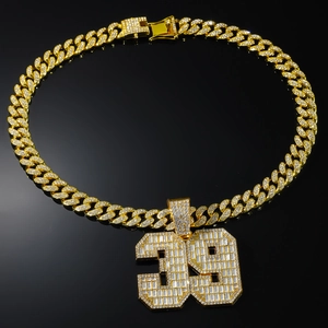 Detail of gold-plated iced out Cuban link chain and number 39 pendant with crystals