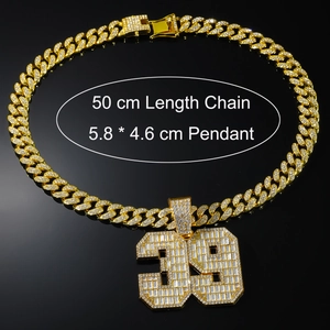 Close-up of gold 39 number pendant with baguette crystals and 50cm Cuban link chain