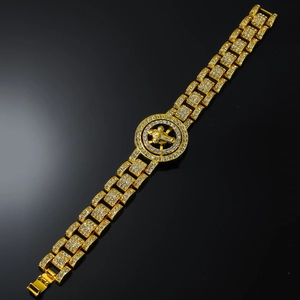 Macro di bracciale hip-hop dorato con croce rotante e cristalli bianchi incastonati
