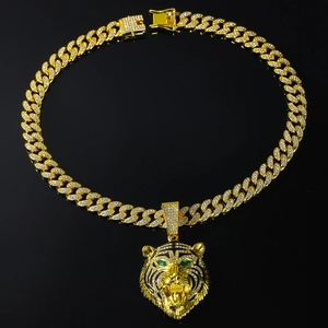 Macro shot of hip hop lion pendant with green eyes and sparkling crystal embellishments