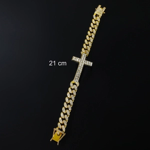 Detail of 21cm gold cuban link bracelet with iced out cross and zircon stones