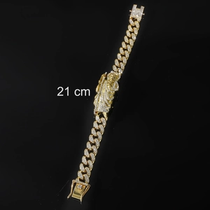 Close-up of a 21cm iced-out Cuban chain with a Saint Jude pendant on a black reflective base