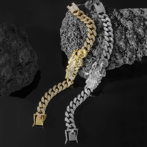 Close-up of gold and silver iced out Cuban chain bracelets with St. Jude religious pendant