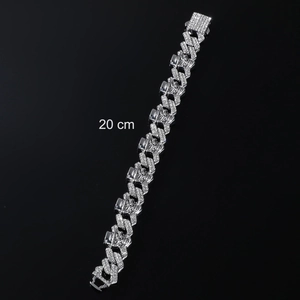Close-up of 20cm silver punk Cuban link bracelet with skull charms and white zircons
