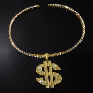 Close-up of gold dollar sign pendant with sparkling diamonds and tennis chain