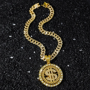Iced out gold Cuban link necklace with rotating dollar sign pendant and pavé rhinestones