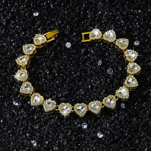 10mm iced out heart link tennis bracelet in gold finish with clear stones and foldover clasp