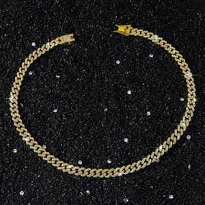 Detail of 9mm wide gold-plated Cuban link necklace with iced out diamond pave setting