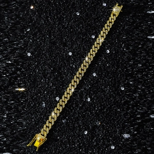Macro shot of 9mm wide gold-tone hip hop chain necklace with sparkling crystals on black stone
