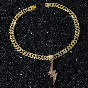Close-up of hip hop gold Cuban link necklace with pink and white iced-out lightning pendant