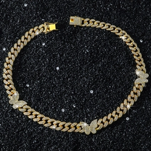 Detail of 13mm gold Cuban link necklace with iced-out butterfly charms and pavé diamonds