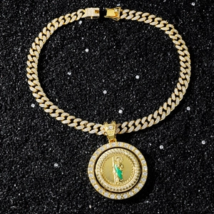 Close-up of golden spinning St. Jude religious pendant with pavé set zircon stones