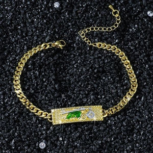Gold Cuban chain bracelet featuring a St. Jude religious pendant with green enamel detail