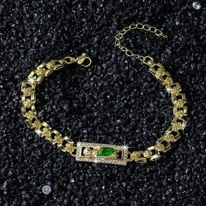 Hip hop style gold bracelet with rose embossed links and emerald green gemstone centerpiece