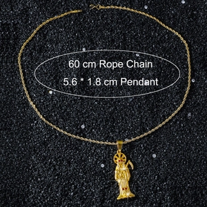 Macro shot of gold Santa Muerte pendant with red gem eyes on 60cm twist chain