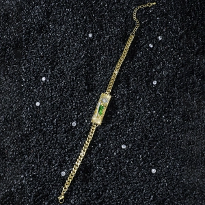 Hip hop St. Jude gold plated curb chain bracelet featuring green and white detailing