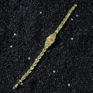 Detailed view of Saint Jude Thaddeus gold bracelet with heart-shaped links on black stones