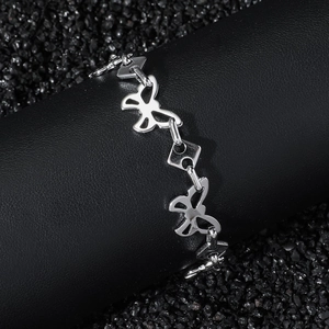 Polished stainless steel butterfly link chain bracelet on a black leather display stand