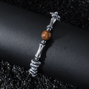 Minimalist beaded tiger eye stone bracelet with hematite beads on a luxury black display